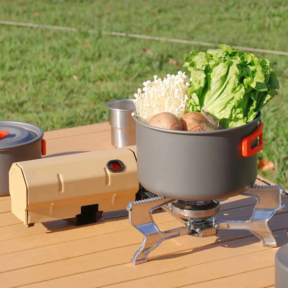 Portable stove with pot on a wooden surface outdoors