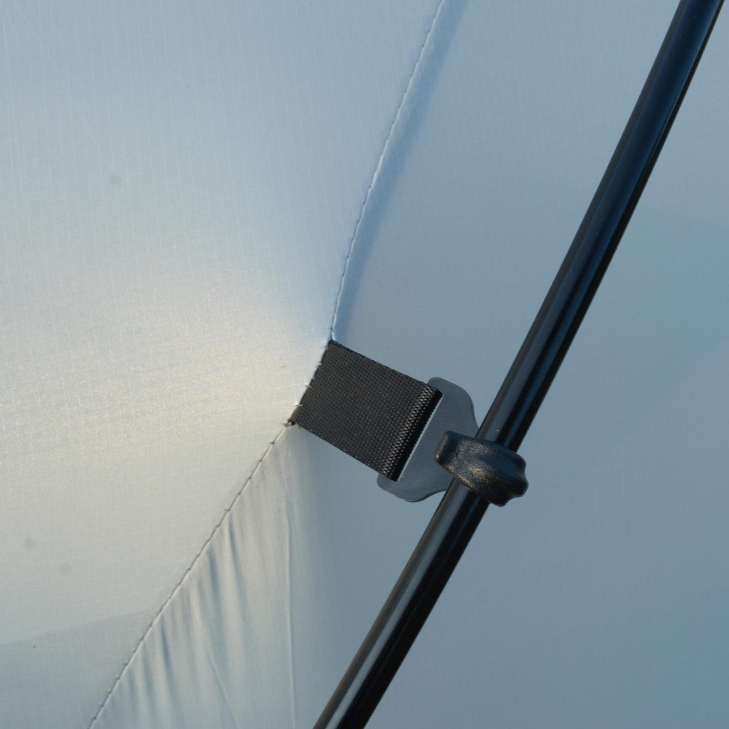 Close-up of a metal bracket on a transparent surface with a blurred background